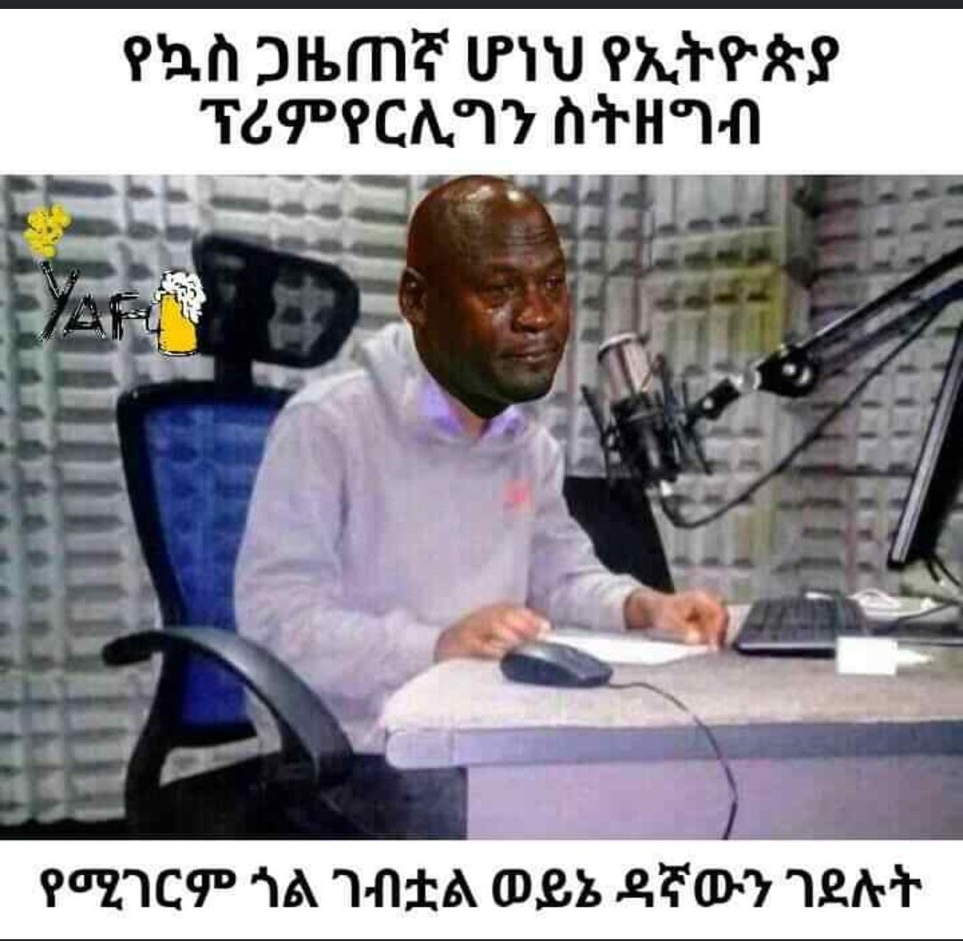 a man sitting at a desk with a microphone